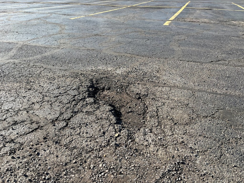 A different early morning snapshot of a pothole in the parking lot
