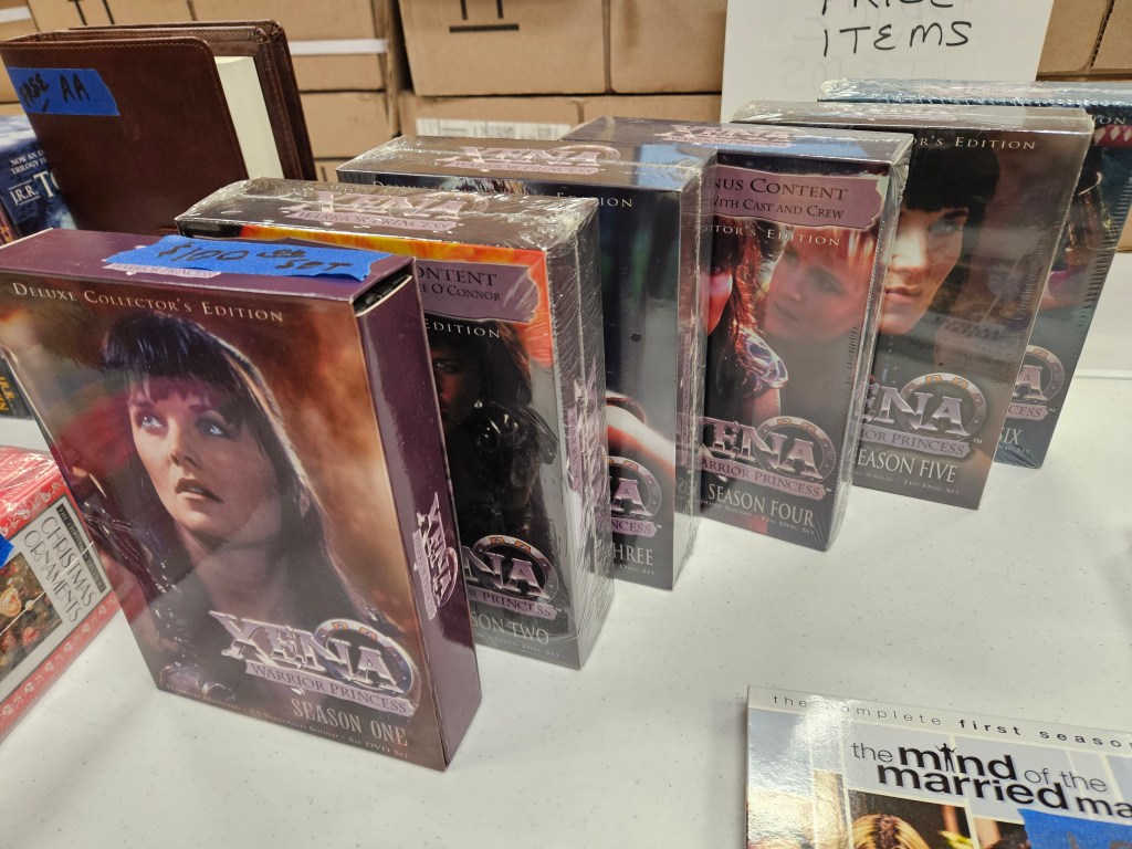 6 sets of boxed DVDs displayed on a table