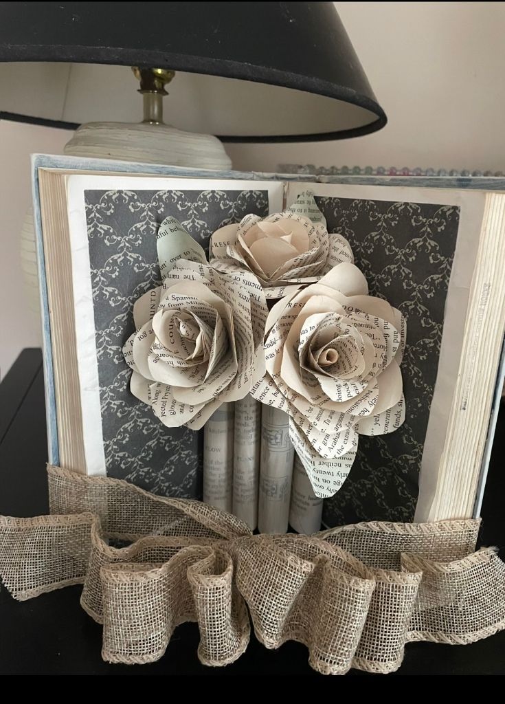 open book embellished and folded to hold book page roses