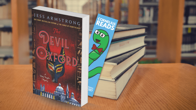 Book titled, The Devil in Oxford, sits upright on a table in front of a stack of books