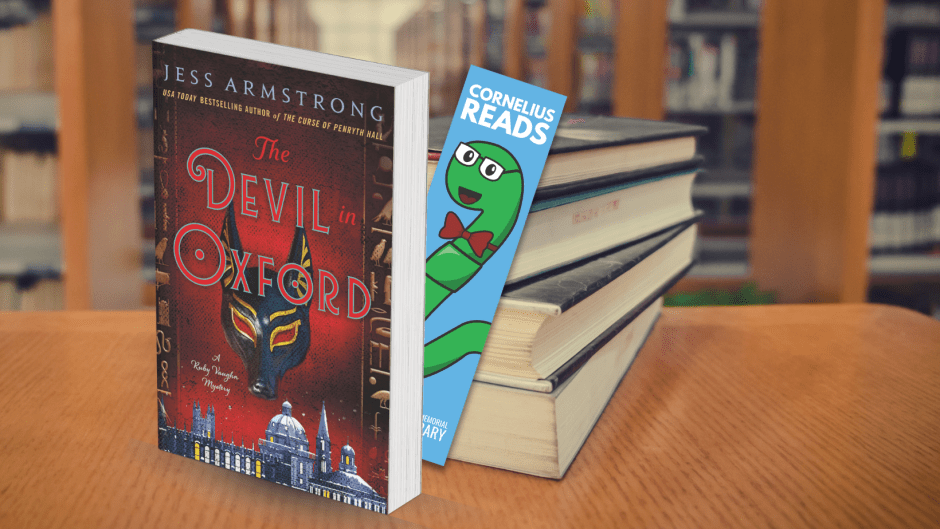 Book titled, The Devil in Oxford, sits upright on a table in front of a stack of books