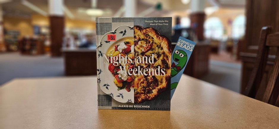 a book titled "Nights and Weekends" sits upright on a table, with a Cornelius Reads bookmark peeking out the side pages